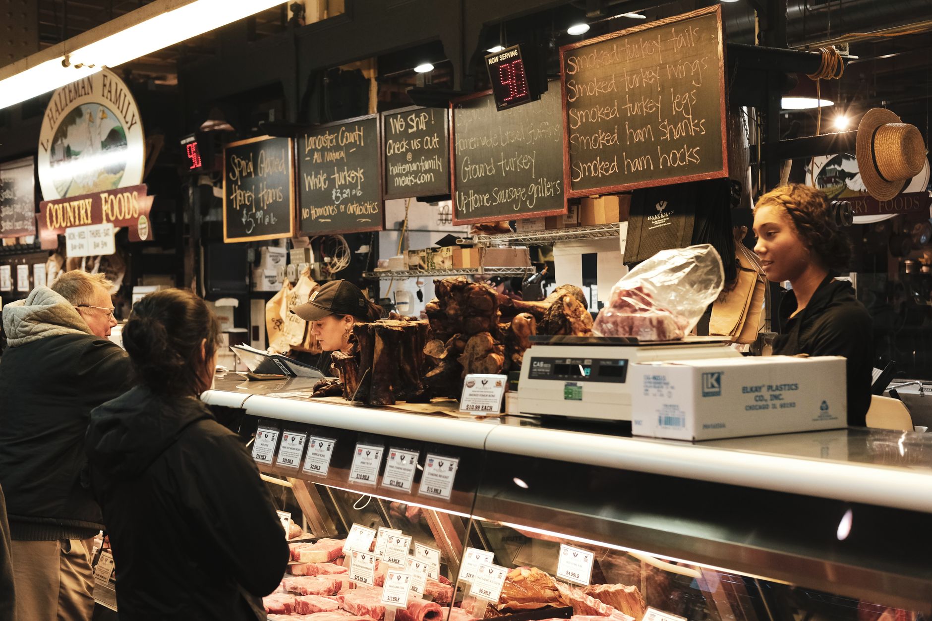 A butcher working behind the counter of a shop