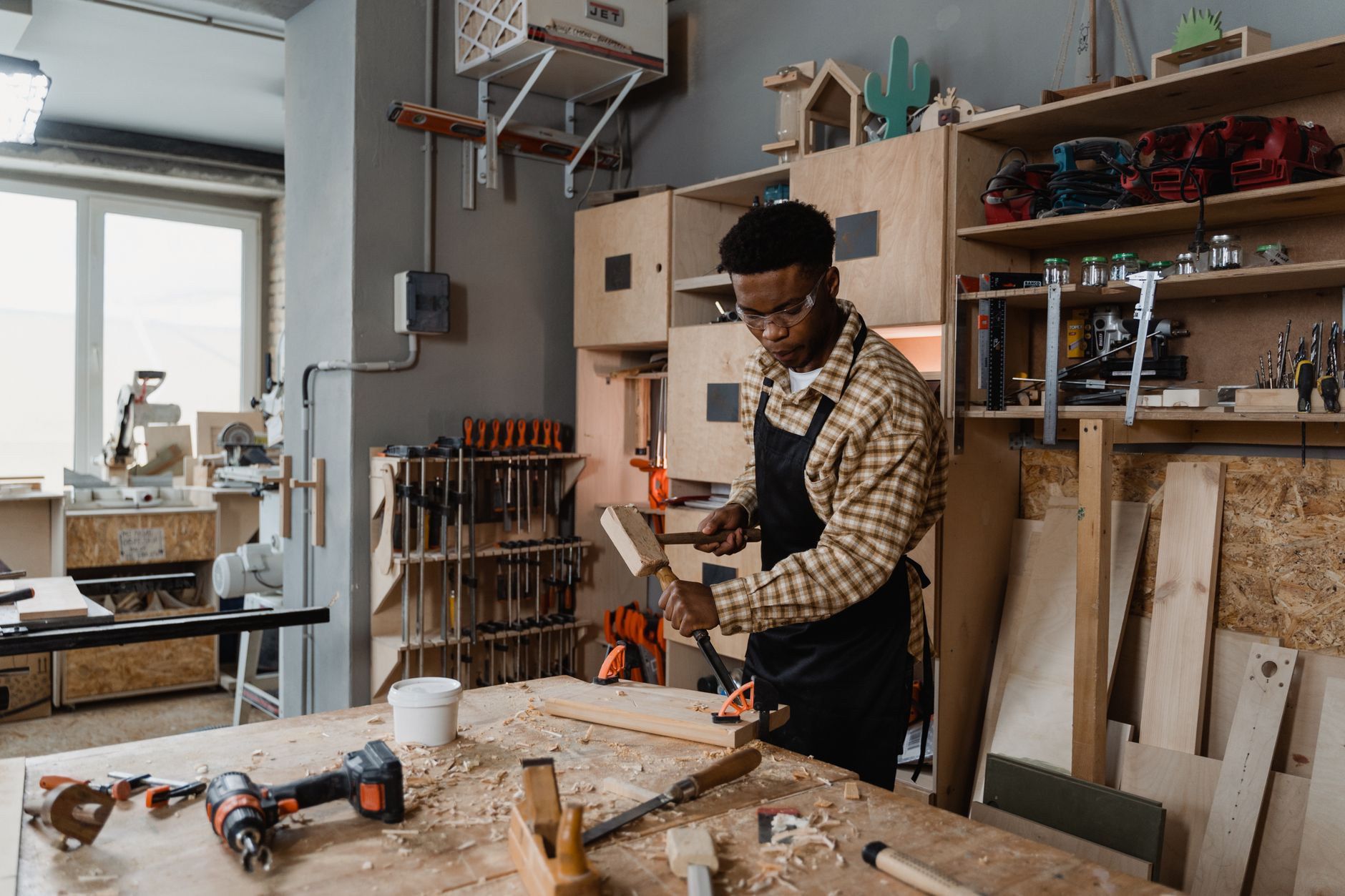 A carpenter at work in a small workshop