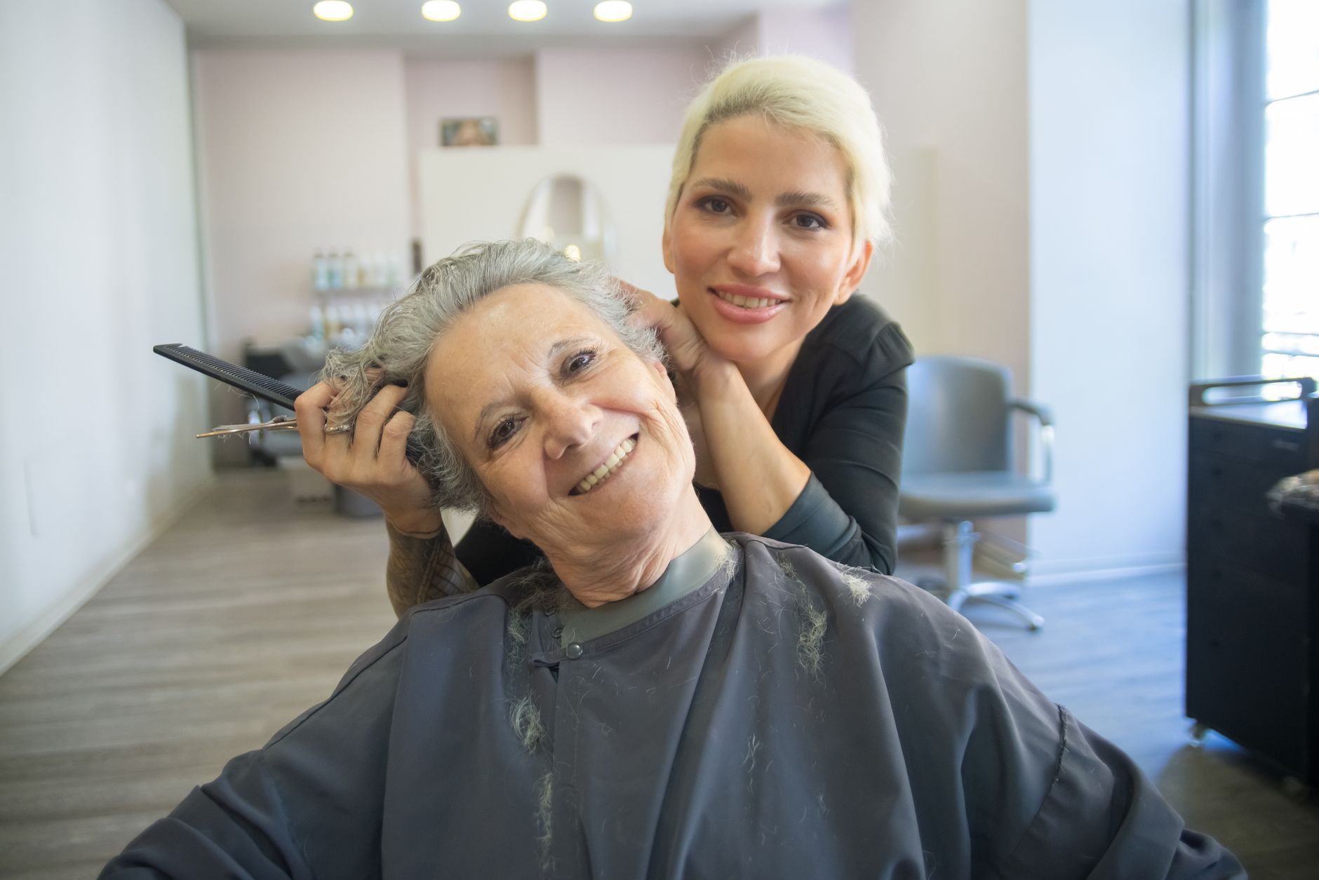 A hairstylist with a client in a small salon