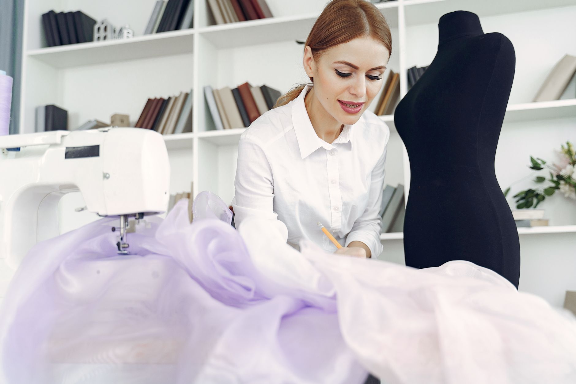 A tailor working at a sewing machine in a small shop